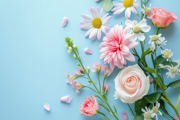 Bouquet of beautiful spring flowers on pastel blue table top view