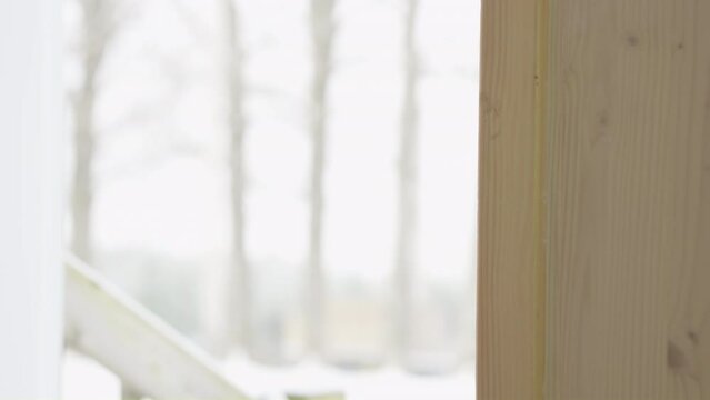 Men hand unlocked and opened a outside door inside view