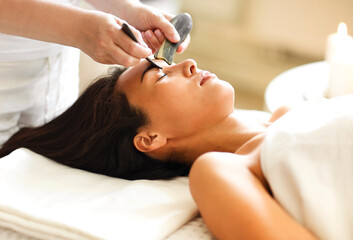 Obraz na płótnie Canvas Face massage or beauty treatment in spa salonFace massage or beauty treatment in spa salon