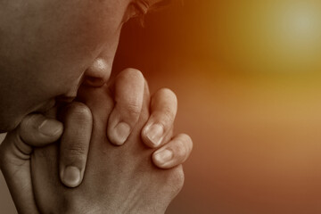 A man praying and close your eyes in praying. Prayer to pray. A young man is holding palms by his...