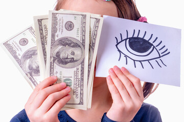 Conceptual photography: double standards. A young girl is holding US Dollar bills and banner with...