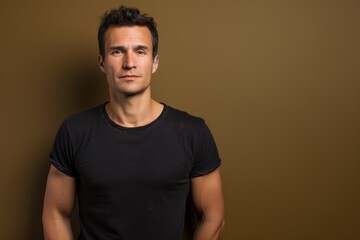 Portrait of a tender man in his 30s sporting a vintage band t-shirt against a solid color backdrop. AI Generation