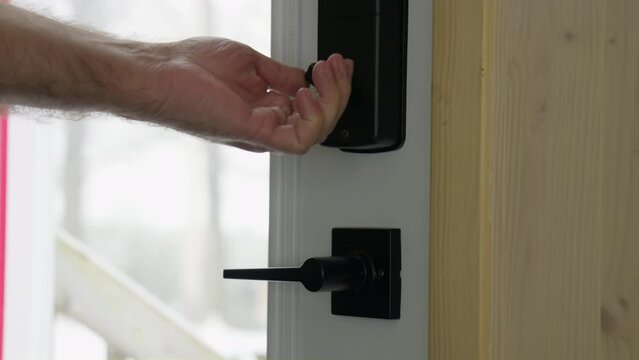 Men hand closed and locked a outside door inside view