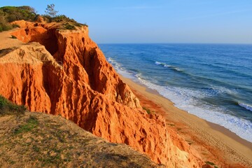 Coastal cliffs and beach Falesia in the sunset light. Algarve Portugal