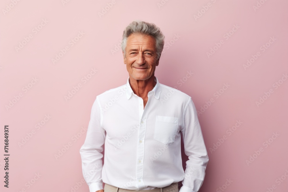 Poster Portrait of a glad man in his 70s wearing a classic white shirt against a solid pastel color wall. AI Generation