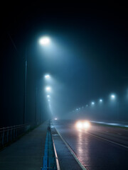 foggy night road, light from car headlights