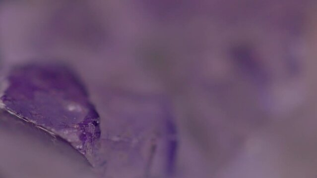 Close up of natural purple fluorite stone texture rotating 