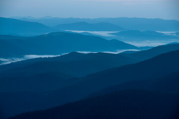 Silhouettes of blue mountain ranges. minimalist landscape in blue tones