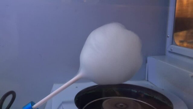 Closeup of making cotton candy in machine. Cotton candy machine