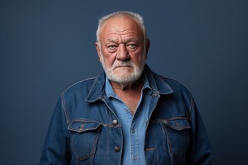 Fototapeta premium Portrait of a content man in his 80s sporting a rugged denim jacket against a blank studio backdrop. AI Generation