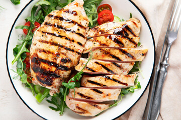 Roasted chicken breast, fillet and fresh vegetable salad.