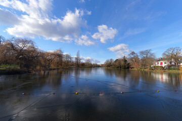 The frozen Daumesnil lake at Bois de Vincennes in the 12th arrondissement of Paris city - obrazy, fototapety, plakaty