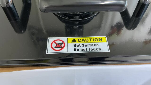 T shirt heat press printing sign Caution Hot Surface Do Not Touch. Close up view shot. 