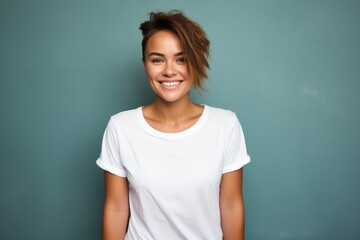 Portrait of a happy woman in her 20s dressed in a casual t-shirt against a plain cyclorama studio wall. AI Generation - obrazy, fototapety, plakaty