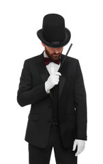 Magician in top hat holding wand on white background