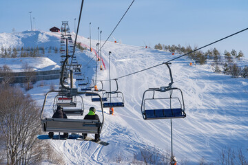 Ski resort in Russia, trails with snow-covered trees and a chairlift, winter day
