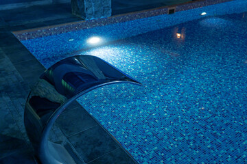 a swimming pool with blue tiles filled with water. Spa area at the hotel in the ski resort