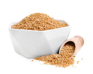 Dry wheat groats in bowl and scoop isolated on white
