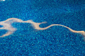 a swimming pool with blue tiles filled with water. Spa area at the hotel in the ski resort