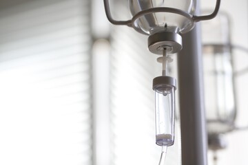 IV drip against blurred background, space for text