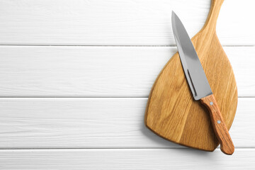 One sharp knife and board on white wooden table, top view. Space for text