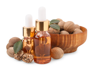 Nutmeg essential oil, nuts and leaves isolated on white