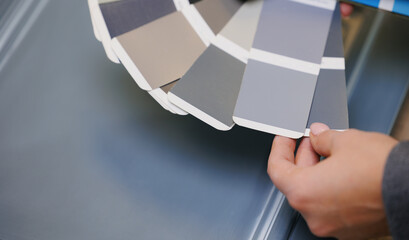 Consultant Woman seller advising client female with color samples and texture for kitchen furniture