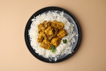 Delicious chicken curry with rice on beige background, top view