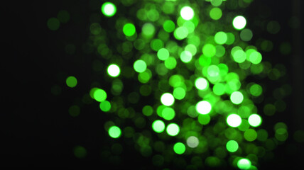 St. Patrick day. Black background with blurred green lights, bokeh effect