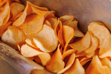 Potato chips production line at food industrial plant. Filling machines for snacks