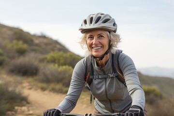 Portrait of a relaxed mature woman practicing mountain biking. With generative AI technology - obrazy, fototapety, plakaty
