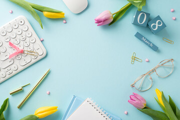 Business lady's desk on Woman's Day: Top view office essentials - keyboard, cube calendar with 8th March, trendy glasses, copybooks, pen, clips, tulips. Pastel blue background for personalized wishes