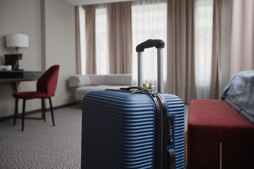 Close up of plastic suitcase in modern hotel room interior, no people, copy space