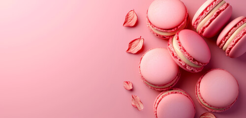 Obraz premium An array of colourful macarons on a vibrant pink surface.