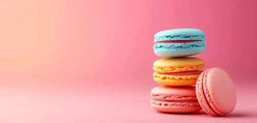 Stacked pastel macarons on a pastel pink backdrop. Ideal for text placement for advert or card.