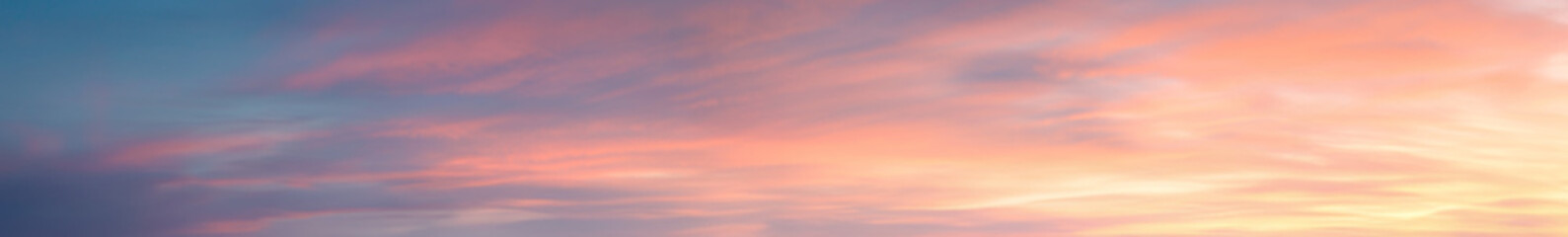 Pastel Vibrant extra wide panoramic sky. Fantasy banner sky. Rich colors. Daytime sunset beauty. Fiery glowing heavenly sky with gradient colors. Red, pink, orange, blue, yellow.