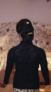 Rear view of a woman with an elegant updo hairstyle
