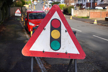 temporary traffic lights ahead warning sign. Triangular road sign warning motorists of signal lights due to lane closure during road maintenance works 
