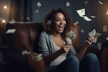 Portrait of a happy woman holding money in her hands and sitting in an armchair. - obrazy, fototapety, plakaty