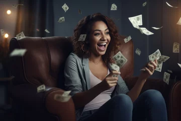 Fotobehang Portrait of a happy woman holding money in her hands and sitting in an armchair. © AI Studio
