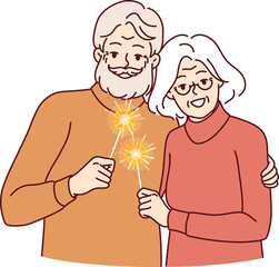 Happy pensioners with sparklers symbolizing christmas stand in embrace together celebrating new year