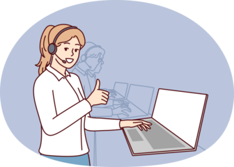 Woman in headphones for call center stands near laptop and looks at camera showing thumbs up. Girl employee of psychological support service or software user consultation smiling