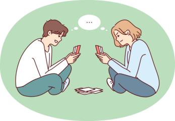 Young man and woman play cards sitting cross-legged on floor and think what next move to make. Youth guy and girl spend their free time together using board game to pass time
