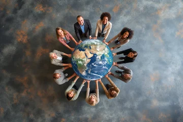Foto op Plexiglas A group of business people holding a planet earth globe together © Dzmitry