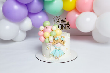 cake with beautiful children's decor on a background of balloons. birthday dessert