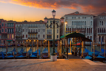 Sunrise on the Grand Canal with gondolas in Venice Italy