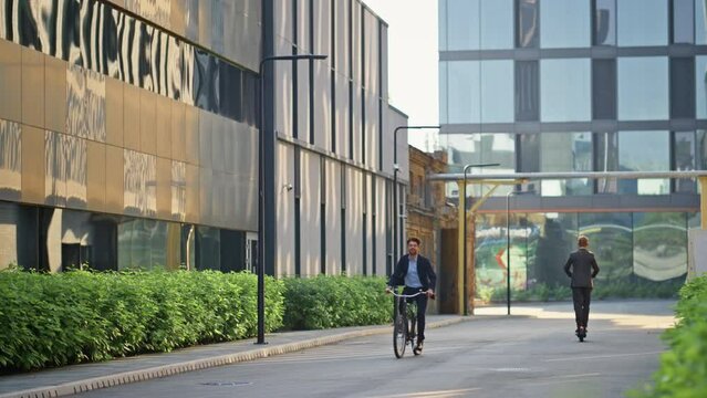 Business people commuting work on empty street. Suit man ride bicycle in morning