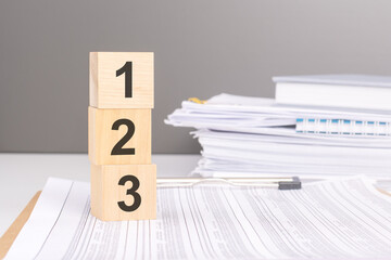 number 1 2 3 on wooden blocks. business concept. gray background, financial document.