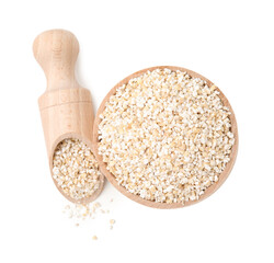 Raw barley groats in bowl and scoop isolated on white, top view