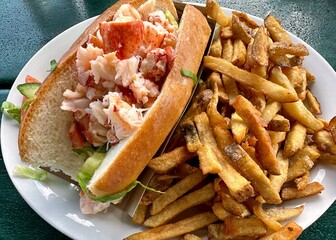 A traditional lobster roll and french fries